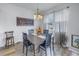 Dining room with a chandelier, wood table, and chairs with natural light from the adjacent window at 8272 Artisan Way, Seminole, FL 33777