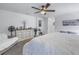 Bright and airy main bedroom with dresser and cozy seating at 8272 Artisan Way, Seminole, FL 33777