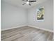 Bright bedroom with wood-look floors and ceiling fan at 8306 N Marks St, Tampa, FL 33604