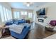 Bright living room with hardwood floors, a sectional sofa, and fireplace at 10452 Gooseberry Ct, Trinity, FL 34655