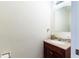 Simple bathroom with granite vanity and large mirror at 1205 Curlew Rd, Dunedin, FL 34698