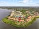 Aerial view of waterfront community with tennis courts and resort-style amenities at 1814 Mariner Dr # 159, Tarpon Springs, FL 34689