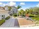 Outdoor BBQ area with picnic tables and umbrellas near clubhouse at 1814 Mariner Dr # 159, Tarpon Springs, FL 34689