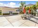 Outdoor BBQ area with picnic tables and umbrellas near clubhouse at 1814 Mariner Dr # 159, Tarpon Springs, FL 34689