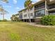 Condo building with lush landscaping and waterfront views at 1814 Mariner Dr # 159, Tarpon Springs, FL 34689