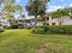 Ground level view of condo building with lush landscaping at 1814 Mariner Dr # 159, Tarpon Springs, FL 34689