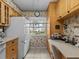 Condo kitchen with light wood cabinets, built-in desk at 1814 Mariner Dr # 159, Tarpon Springs, FL 34689
