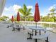 Community patio with tables, umbrellas, and pool view at 1814 Mariner Dr # 159, Tarpon Springs, FL 34689