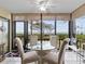 Bright sunroom boasts stunning water views and a glass-top table at 1814 Mariner Dr # 159, Tarpon Springs, FL 34689