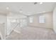 Spacious loft area with carpeted flooring and two windows at 1952 Marlington Way, Clearwater, FL 33763