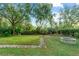 Landscaped backyard with fire pit and stone path at 4104 Warwick Hills Dr, Wesley Chapel, FL 33543