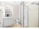 Bathroom featuring a shower with glass door, single vanity, and neutral tile flooring at 4104 Warwick Hills Dr, Wesley Chapel, FL 33543