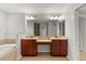 Bathroom features double vanity and large mirror at 4104 Warwick Hills Dr, Wesley Chapel, FL 33543