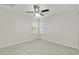 Bedroom with two windows and neutral-toned carpet at 4104 Warwick Hills Dr, Wesley Chapel, FL 33543