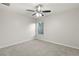 Well-lit bedroom with a ceiling fan and carpeted floor at 4104 Warwick Hills Dr, Wesley Chapel, FL 33543