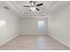 Bright bedroom with laminate wood flooring and a ceiling fan at 4104 Warwick Hills Dr, Wesley Chapel, FL 33543