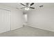 Well-lit bedroom with double door closet and carpet flooring at 4104 Warwick Hills Dr, Wesley Chapel, FL 33543