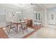 Inviting dining room with stylish furniture, a modern chandelier, and plenty of natural light from the window at 4104 Warwick Hills Dr, Wesley Chapel, FL 33543