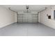 Attached garage with epoxy flooring and storage at 4104 Warwick Hills Dr, Wesley Chapel, FL 33543