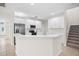 Bright kitchen featuring white cabinets, stainless steel appliances, a breakfast bar, and ceramic tile flooring at 4104 Warwick Hills Dr, Wesley Chapel, FL 33543