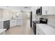 Bright kitchen with stainless steel appliances, white cabinets, and a large island perfect for entertaining at 4104 Warwick Hills Dr, Wesley Chapel, FL 33543