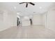 Spacious living area with tile flooring, open floor plan, and easy access to the kitchen and staircase at 4104 Warwick Hills Dr, Wesley Chapel, FL 33543