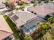 Aerial view showing the house, pool, and surrounding neighborhood at 5006 Ruby Flats Dr, Wimauma, FL 33598