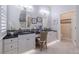 Spa-like bathroom with double vanity and granite countertop at 5006 Ruby Flats Dr, Wimauma, FL 33598