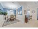 Charming dining room with blue walls and wicker chairs at 5006 Ruby Flats Dr, Wimauma, FL 33598