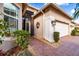 Front entry with double doors and a brick walkway at 5006 Ruby Flats Dr, Wimauma, FL 33598