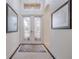 Bright entryway with double doors and stylish rug at 5006 Ruby Flats Dr, Wimauma, FL 33598