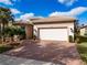 White two-car garage with brick driveway at 5006 Ruby Flats Dr, Wimauma, FL 33598