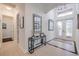 Bright hallway with glass-top console table and framed art at 5006 Ruby Flats Dr, Wimauma, FL 33598