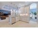 Modern kitchen with white cabinets, granite countertops, and stainless steel appliances at 5006 Ruby Flats Dr, Wimauma, FL 33598
