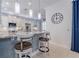 Kitchen with breakfast bar, white cabinets, and granite countertops at 5006 Ruby Flats Dr, Wimauma, FL 33598