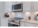 Stainless steel appliances and granite countertops in a modern kitchen at 5006 Ruby Flats Dr, Wimauma, FL 33598