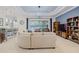 Living room with sectional sofa, built-in shelving, and pool access at 5006 Ruby Flats Dr, Wimauma, FL 33598