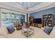 Comfortable living room with built-in shelving and large TV at 5006 Ruby Flats Dr, Wimauma, FL 33598