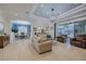 Spacious living room with leather armchairs and pool view at 5006 Ruby Flats Dr, Wimauma, FL 33598