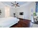 Spacious main bedroom with hardwood floors and sliding doors to patio at 5006 Ruby Flats Dr, Wimauma, FL 33598