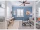 Home office with built-in desk and comfortable seating area at 5006 Ruby Flats Dr, Wimauma, FL 33598