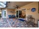 Covered patio with tile flooring, seating area, and view of the interior at 5006 Ruby Flats Dr, Wimauma, FL 33598