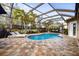 Relaxing pool area with a covered patio and lounge chairs at 5006 Ruby Flats Dr, Wimauma, FL 33598