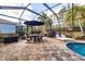 Spacious screened-in pool area with patio furniture and grill at 5006 Ruby Flats Dr, Wimauma, FL 33598