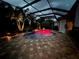 Luminous pool at night with a covered patio at 5006 Ruby Flats Dr, Wimauma, FL 33598