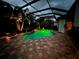 Luminous pool at night with a covered patio at 5006 Ruby Flats Dr, Wimauma, FL 33598