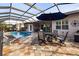 Relaxing pool area with patio furniture and covered lanai at 5006 Ruby Flats Dr, Wimauma, FL 33598