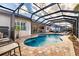 Inviting kidney-shaped pool with covered patio at 5006 Ruby Flats Dr, Wimauma, FL 33598