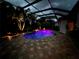 Enjoy this relaxing pool area at night with lighting and comfortable seating at 5006 Ruby Flats Dr, Wimauma, FL 33598