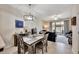 Bright dining area with table and chairs, view into living room and kitchen at 5014 Blue Latan Ln, Tampa, FL 33610